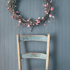 Apple blossom wreath hanging on coat hook with chair by Sandra Cunningham