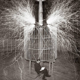 Nikola Tesla Sitting In His Colorado Springs Laboratory With His Magnifying Transmitter by Unknown