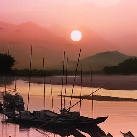 sunset at Mae Khong river by Setsiri Silapasuwanchai
