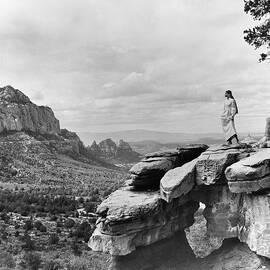 Veruschka on a Barren Cliff in the Arizona Desert by Franco Rubartelli