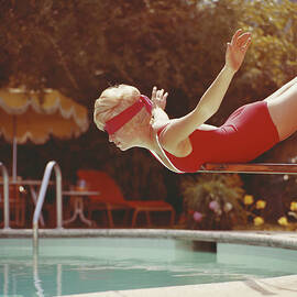 Young Woman With Blindfold Balancing On by Tom Kelley Archive